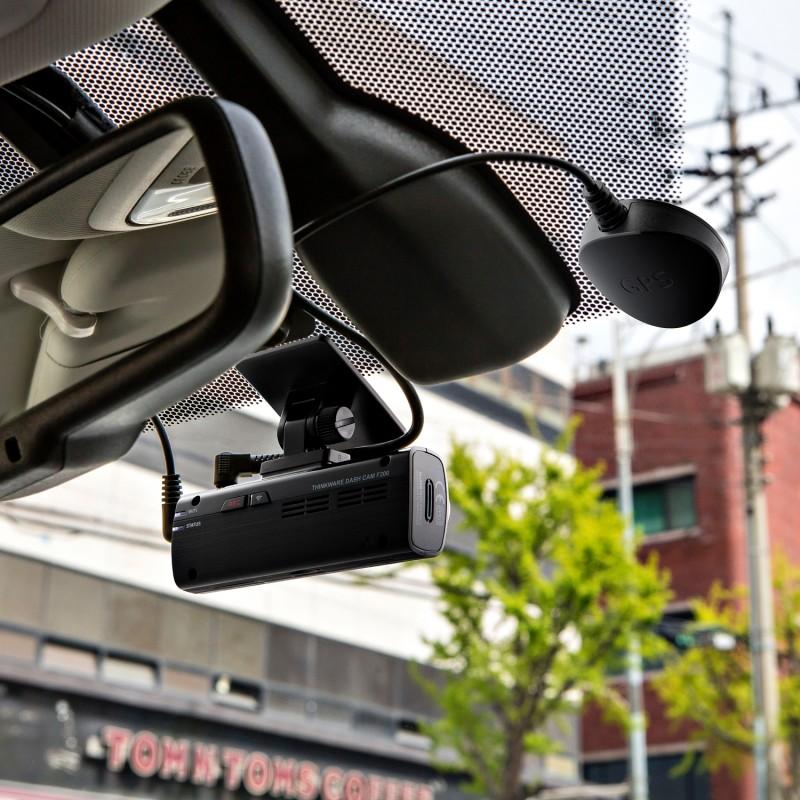 Wireless dash cam mounted on a car windshield for recording the road